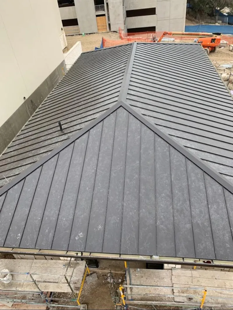 Commercial metal roof construction with crane equipment in Innsbrook