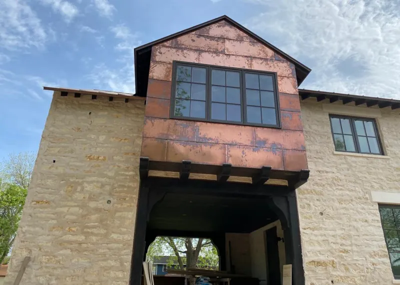 Copper metal panel facade on a stone building for Skylight Installation in Innsbrook